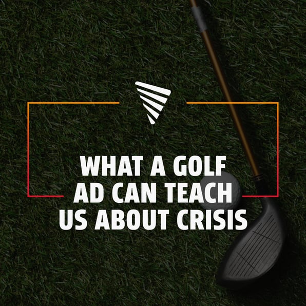 Overhead view of a golf club resting next to a golf ball on green grass with text reading, 